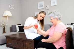 woman working with physical therapist