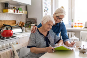 caregiver and woman working in the kitchen